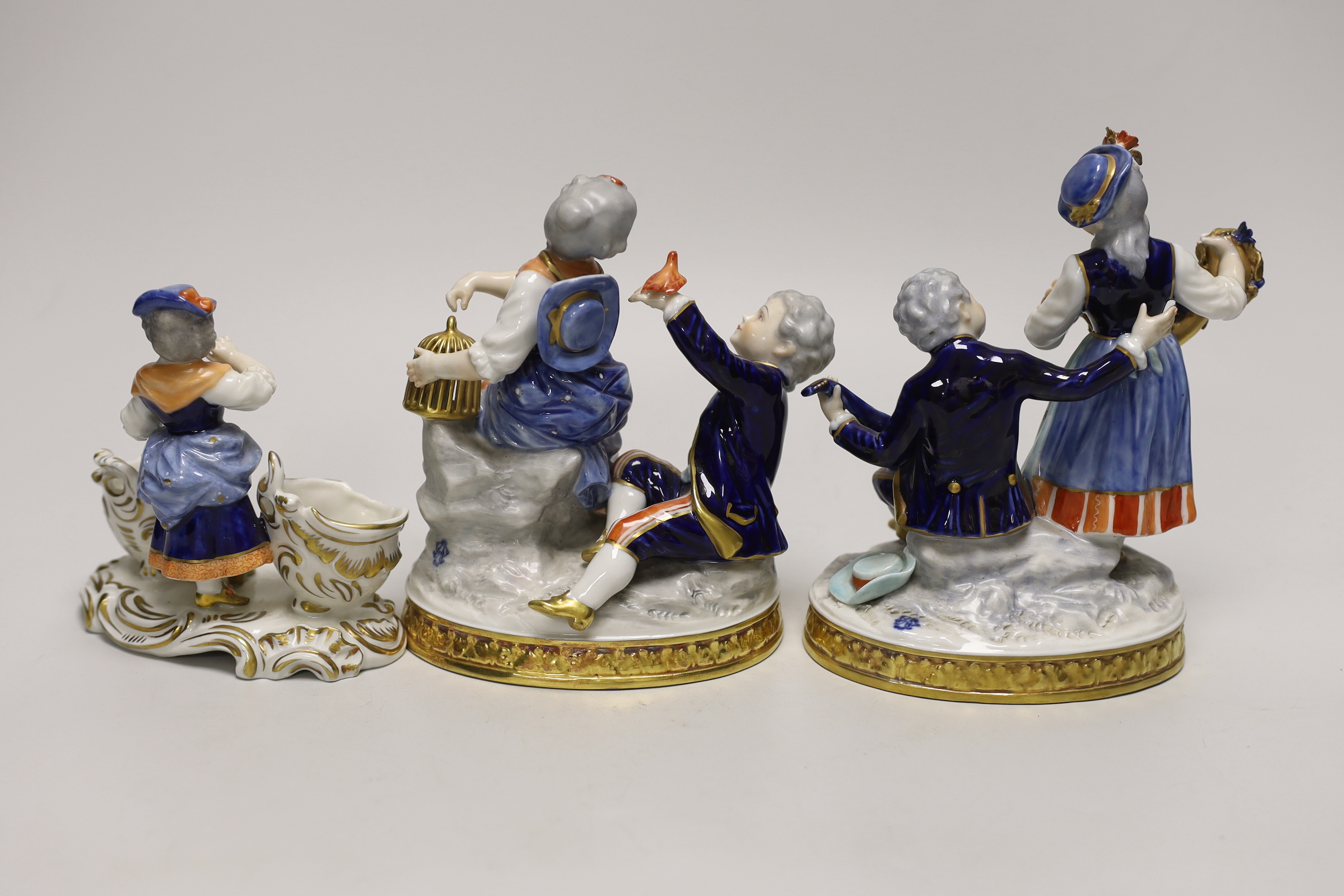 Two German porcelain figure groups and figural salt, tallest 17cms high